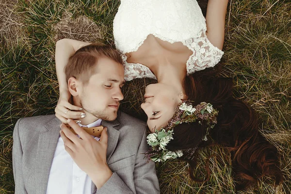 depositphotos_149444048-stock-photo-newlyweds-lying-on-grass